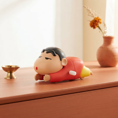 Shinchan crawling toy displayed on a terracotta surface in a bright, modern room with minimalist decor.